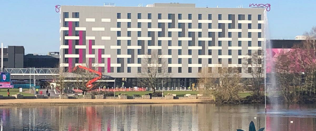 Moxy hotel Birmingham in distance behind pond